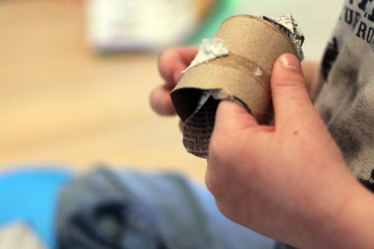 stuff the toilet paper tube with the newspaper